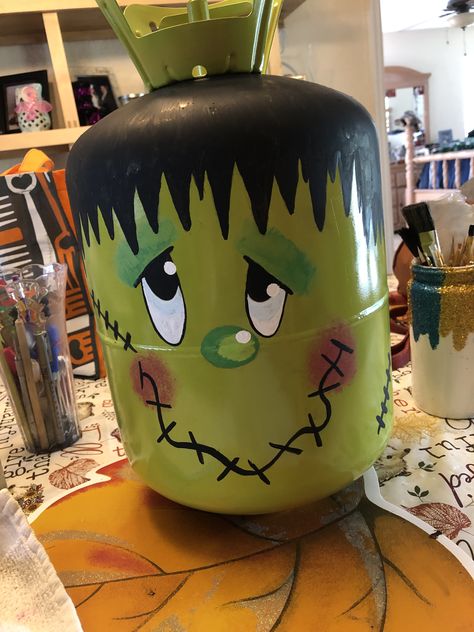 I made this for my grandkids to decorate for Halloween at their house. Made with old/empty Freon tank. Painted by hand. Halloween Propane Tank, Propane Tank Halloween Decorations, Frankenstein Propane Tank, Old Propane Tanks Ideas, Propane Tank Pumpkins, Freon Tank Art, Freon Tank Diy Projects, Halloween Trash Can, Hollowed Decorations