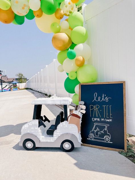 golf summer kids birthday parties, sports birthday, summer birthday ideas, summer birthday themes Golf Gender Reveal Balloon Arch, Cardboard Golf Cart, Golf Party Photo Backdrop, Masters Golf Birthday Party, Golf Pinata, Par Three Birthday, Masters Party Decorations, Partee Golf Party, Golf Party Decor