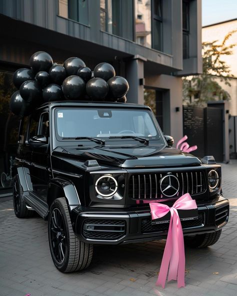 Embrace the elegance of celebration with this breathtaking scene featuring a luxurious black Mercedes-Benz G-Class. Adorned with a charming pink bow and surrounded by sleek black balloons, it's a vision of sophistication. ✨Don't forget to save and follow for more captivating visuals!👉 #LuxuryLifestyle #CelebrationVibes #MercedesBenzGClass #BlackAndPinkElegance #CarGoals #Aesthetic #AIImage G Wagon Vision Board, All Black Cars Luxury, G Wagon With Bow, Pink G Class Mercedes, Mercedes Benz Vision Board, Black G Wagon Pink Interior, Pink G Wagon Mercedes Benz, Pink Mercedes Benz Aesthetic, G Wagon Gift