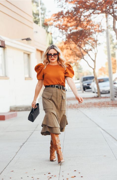 Orange Puff Sleeve, Cargo Skirt. midi skirt outfit winter | puff sleeve top | midi skirt street style winter | chic winter layers | women fashion winter | puff sleeve outfit winter | cargo skirt outfit street styles | midi skirt outfit winter boots | Fashion blogger | knee high boots | Hunter Collector #puffsleeve #midiskirtoutfit #winteroutfits Orange And Khaki Outfits, Army Green Skirt Outfit, Green Skirt Outfit, Short Orange Dress, Beige Midi Skirt, Classic Work Outfits, Bright Orange Dress, Army Green Skirt, Oversized Grey Sweater