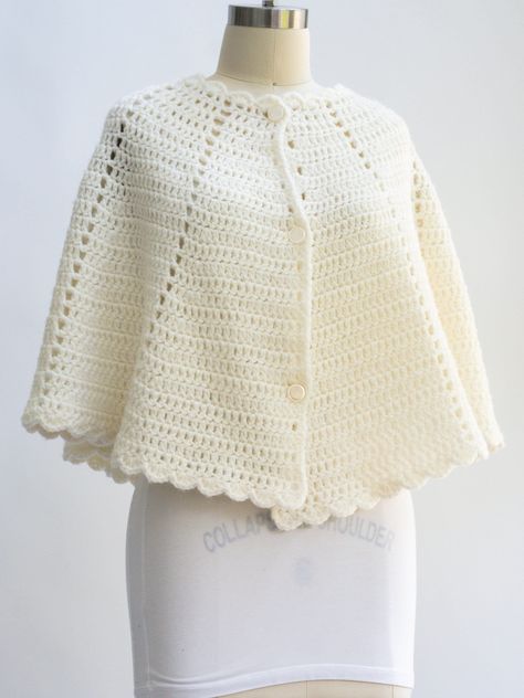 Vintage crochet swing collar poncho sweater in MINT condition. Super chic and cozy. Ivory wool. Looks great over coats and blazers. Size: OSFA Length: 20 inches Pit to pit: Free Pockets: None Lining: None Fasteners: 3 ivory, bakelite buttons; intact Color: Ivory Fabric: Wool blend  Care: And wash in cold water, blot to dry Condition: Mint Crochet Blazer, Over Coats, Sleeveless Sweaters, Bakelite Buttons, Hand Knit Poncho, Crochet Garments, Sleeveless Jumper, Ivory Fabric, Sweater Vest Women