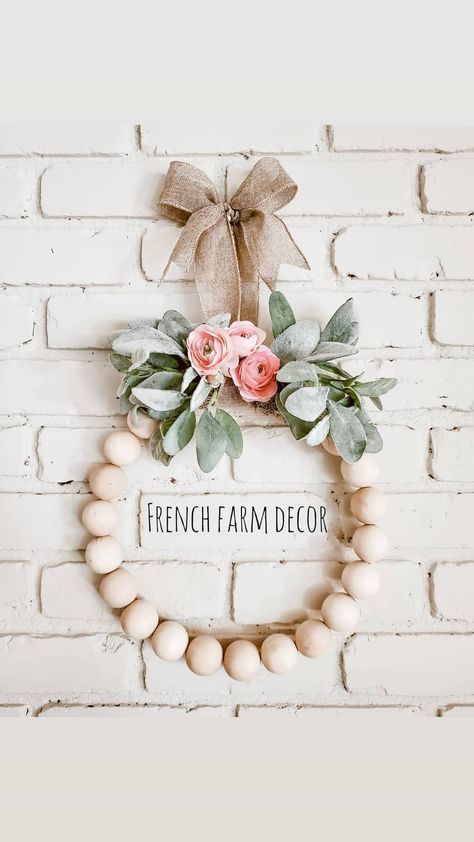 Large wood beads strung onto a hoop wreath mixed with lamb's ear and florals Wood Beads Wreaths, Beaded Wreath With Flowers, Wood Bead Wreath Diy Spring, Wood Bead Floral Wreath, Bead Hoop Wreath, Ring Wreaths Floral, Wood Beads Wreath, Dollar Tree Wooden Bead Wreath, Wood Ball Wreath