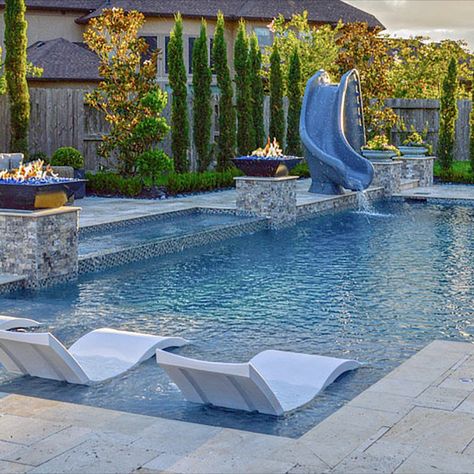 Pebble surfaces are all the rage when it comes to interior pool surfaces of custom-built swimming pools. If you are looking to have an oasis in your backyard or update your current oasis, and you are looking for low maintenance, using pebble finishing on your pool’s surface is a great option.  Here is an example of Pebble Tec in French Gray Pebble Finish Pool, French Grey Pebble Sheen Pool, Pebblecrete Pool Colours, Grey Stone House, Interior Pool, Rock Walkway, Pebble Tec Pool, Stone Backyard, Pool Plaster