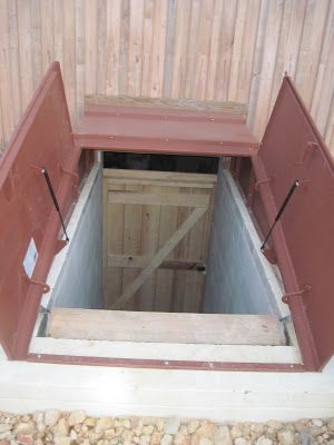 Building our root-cellar was easy! (Ha ha) Just follow these simple steps:  1) Dig a hole. Our hole was 10 feet deep, 30 feet long, and 15 f... Case Sotterranee, Root Cellar Storage, Bilco Doors, Storm Cellar, Concrete Work, Storm Shelters, Root Cellars, Basement Doors, Underground Shelter