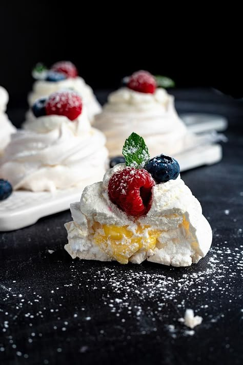 Pavlova is one of the most delicate desserts ever. I love making this berry almond pavlova with lemon curd and I love eating it! Learning an easy pavlova recipe means you can make this impressive dessert whenever the mood hits. Plus it is a bonus that it is a gluten free dessert. If you are looking for a recipe for a dessert with fresh berries or an easy pavlova recipe, this is one to try! Have you ever had pavlova with lemon curd? #pavlova #glutenfree #dessert #eggwhite #berries #lemoncurd Pavlova With Lemon Curd, Easy Pavlova Recipe, Easy Pavlova, Lemon Curd Pavlova, Delicate Desserts, Berry Pavlova, Pavlova Dessert, Impressive Dessert, Gluten Free Dessert