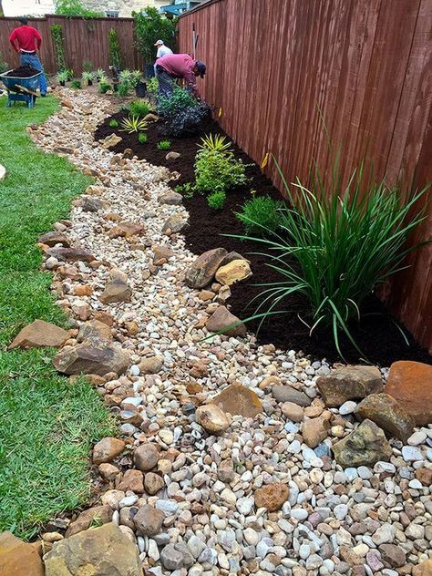 38 Striking Rain Garden Landscaping Ideas Color Rocks Landscaping, Backyard Dry Creek Landscaping, Dry Creek Garden, Rock Garden Around House, Dry Creekbed Garden, Rock Garden Side Of House, River Rock Backyard Landscaping, Plants With Rocks Around, Backyard Rain Garden