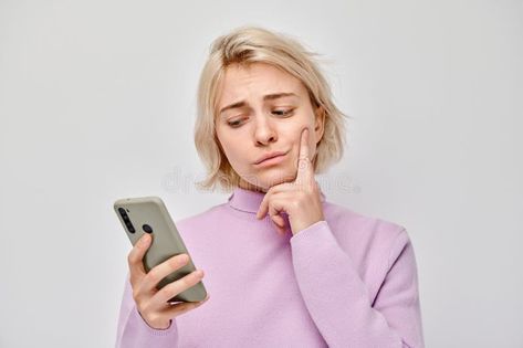 Portrait of young blond woman looks on mobile phone and thinks. Person with smartphone royalty free stock image Blond Woman, Blank Background, Smiling Face, Female Images, Smile Face, Pose Reference, Stock Images Free, Photo Image, That Look