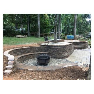 Multi-Level Paver Patio with Staircase and Seating - Traditional - Patio - Charlotte - by Charlotte DreamScapes | Houzz Fire Pit Patio With Retaining Wall, Round Retaining Wall Ideas, Patio Seating Wall, Hillside Playground, Curved Retaining Wall, Round Lawn, Forest Neighborhood, Retaining Wall Patio, Seating Wall