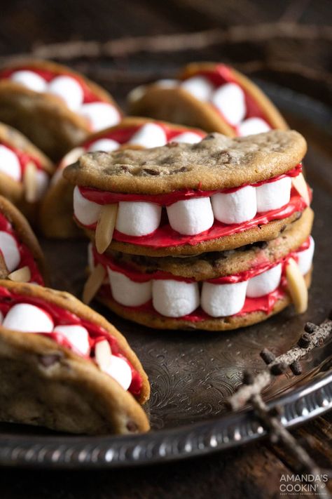 Bloodsucking vampire sandwich cookies are frightfully delicious and super easy to make. Mini marshmallows and slivered almonds are sandwiched between two halves of one chocolate chip cookie bound together with a smear of red frosting! Decorated Halloween Cookies, Cute Halloween Cookies, Halloween Chocolate Chip Cookies, Red Frosting, Owl Treats, Diy Decorating Ideas, Kid Snacks, Vampire Halloween, Spooky Stuff