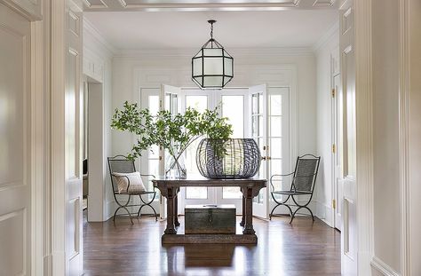 With a center table, a pair of antique chairs, and a lantern by Suzanne Kasler, the house’s grand entrance hall is airy and inviting. Morris Lantern, Grey Dining Room, Manhattan Apartment, Pallet Planter, Weekend House, Edie Parker, Entry Hall, Planter Box, Entry Way