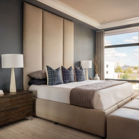 This primary bedroom is truly a one-of-a-kind bespoke space created for these happy clients. The Henck Design team employed local furniture makers to create a soaring floor-to-ceiling upholstered headboard. This 12 foot expansive master bedroom has a wall-mounted custom upholstered primary bed boasting a matching bench at the end of the bed for this sleek, contemporary bedroom. Ceiling Height Headboard, Floor To Ceiling Headboard, Leather Bed Bench, Ceiling Headboard, Tall Upholstered Headboard, Primary Bed, Contemporary Headboards, Modern Classic Interior, Solid Bed