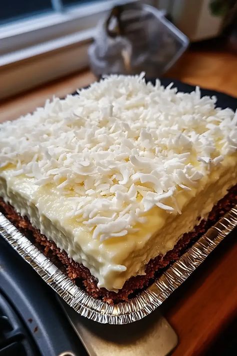 Coconut Cream Lush is an irresistible layered dessert with graham cracker crust, creamy coconut filling, and a fluffy whipped topping with toasted coconut! Ideal for gatherings, parties, or anytime you crave a tropical treat. This make-ahead dessert is even better the next day, so prepare it early and let the flavors blend! Save this recipe and wow your guests! 🥥🍰 Dessert With Graham Cracker Crust, Coconut Cream Lush, Coconut Filling, Layered Dessert, Coconut Dessert, Make Ahead Desserts, Layered Desserts, Cracker Crust, Graham Cracker Crust