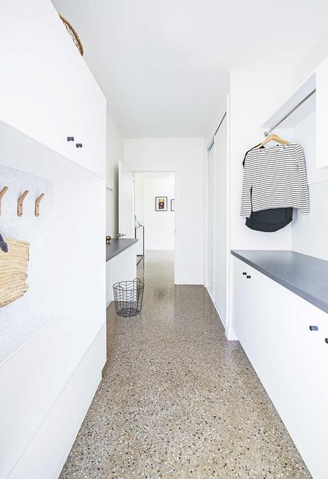 Laundry: Terrazzo floors make the white galley-style laundry pop. A hanging rail above allows for additional storage, and ample cabinetry provides even more space. | Design: Cato Constructions | Photography: Matthew Gianoulis. | These 4 laundry spaces are filled with clever ideas Cute Bunk Bed Ideas, Ikea Laundry, Contemporary Laundry Room, Queenslander Renovation, Utility Room Designs, Terrazzo Floors, White Laundry, Laundry Design, Modern Laundry Rooms