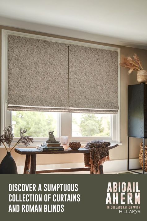 Nola Camo Roman Blind at a large window. There is a wooden table underneath the window next to a vase of faux flowers, Neutral Roman Blinds, Abigail Ahern, Blinds Curtains, Block Colour, Home View, Roman Blind, Roman Blinds, Book An Appointment, Free Sample