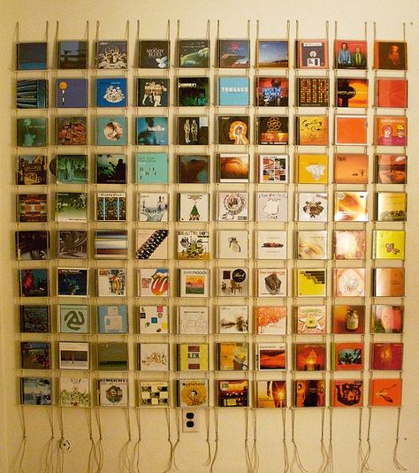 CD cases.  You could use actual album art, or photos or scrapbook paper.  It's nice how color gradation was employed. Ikea Dvd Storage, Dvd Storage Tower, Dvd Storage Cabinet, Dvd Storage Shelves, Dvd Storage Boxes, Cd Wall Art, Cd Wall, Cd Dvd Storage, Cd Diy