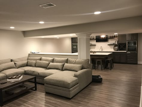 Urban Basement Ideas, Basement Couch Layout, Finished Basement Ideas Layout, Narrow Basement Layout, Finished Basement With Bar, Small Basement Ideas Layout, Furnished Basement, Basement Sofa, Basement Layouts