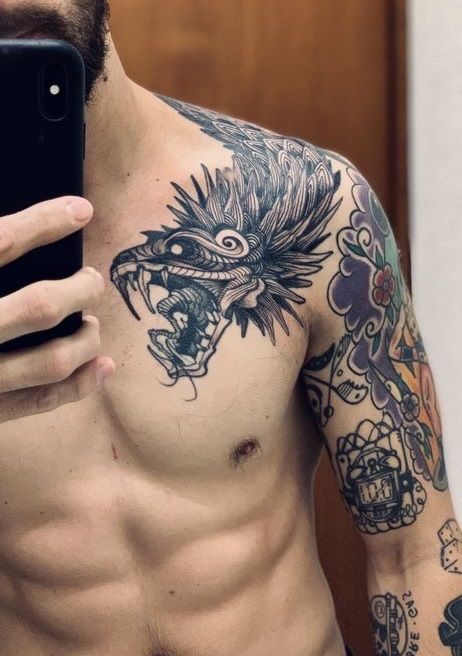 Latest 50 Dragon Tattoo Designs, their Meaning and Patterns Mens Deltoid Tattoo, Quetzalcoatl Back Tattoo, Mayan Snake Tattoo, Aztec Snake Tattoo Design, Tattoo Collarbone Men, Mayan Tattoos Sleeve, Aztec Serpent Tattoo, Mexican Tattoo Ideas For Men, Quetzalcoatl Tattoo