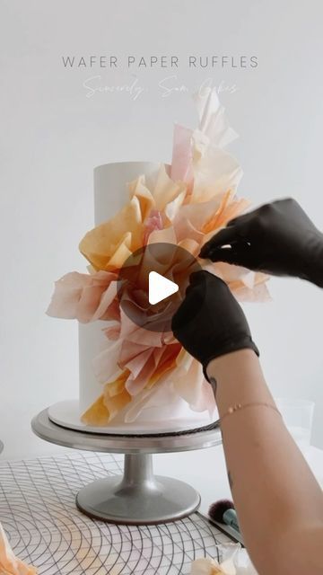 Sincerely, Sam Cakes on Instagram: "WAFER PAPER RUFFLE TIPS 👇🏼  In the first video, you will see a large portion of the cake has been covered with wafer paper (flat against the cake.) I simply use water/steam to stick. I don’t always use this method as it’s not always necessary but, when it comes to coloured wafer, the oil reduces the tackiness of the paper & it needs a little effort to stick. Method from @alcakemy   Usually, the way I shape my ruffles allows me to insert a long wire into the base. Comment ‘VIDEO’ & I will send a DM with video snippets on how to wire ruffles 💞  - Insert wires into ‘main’ ruffles (these will hold the shape of the total placement.)  - To create shape & stability, use a cake steamer. The steam will help the wafer become tacky & you can stick pieces togethe Wafer Paper Decorations, Rice Paper Decorated Cakes, Wafer Paper Cake Tutorial, Wafer Paper Cake Decoration, Cake Steamer, Wafer Paper Tutorial, Mexican Cake, Red Birthday Cakes, Ruffle Wedding Cake