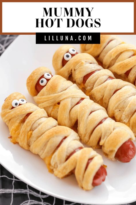 Buttery crescent-wrapped mummy hot dogs are filled with cheese and topped with cute candy eyes for spooky kid-friendly fun!! #mummydog #mummyhotdog #halloween #halloweendinner #halloweenappetizer Mummy Hot Dogs Crescent Rolls, Halloween Party Platter, Mummy Hot Dogs Recipe, Halloween Mummy Hot Dogs, Halloween Mummy Dogs, Halloween Hotdogs, Fun Halloween Party Food, Mummy Hot Dogs, Pasteles Halloween