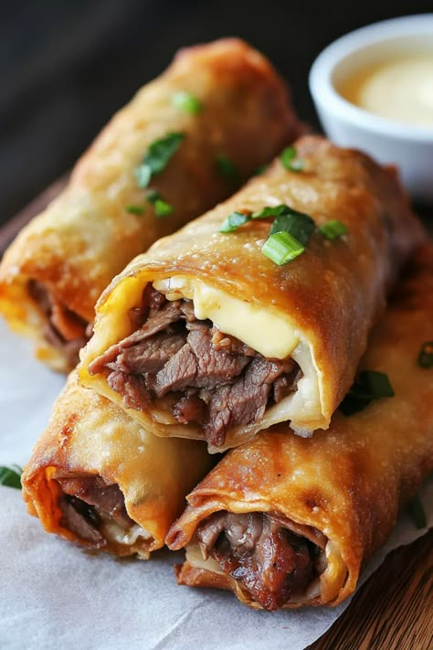 A fusion of Asian and American cuisine, combining thinly sliced Egg Rolls Filled With Philly Cheesesteak, Chicken Parm Egg Rolls, Venison Egg Rolls, Soul Food Egg Rolls Recipes, Philly Cheese Steak Rolls, Philly Cheese Steak Egg Rolls, Cheese Steak Egg Rolls, Steak Egg Rolls, Egg Roll Wrapper