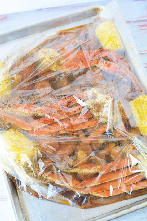 How to cook seafood in a bag in the oven! Crab boil in a Reynolds oven bag with corn, sausage and shrimp in 30 minutes tender with Old Bay. Seafood Boil Recipes Oven, Seafood In A Bag, Shrimp Boil In Oven, Crab Boil Recipe, Steamed Crab Legs, Instant Pot Beans Recipe, Cooking Crab Legs, Cooking Crab, Crab Legs Recipe