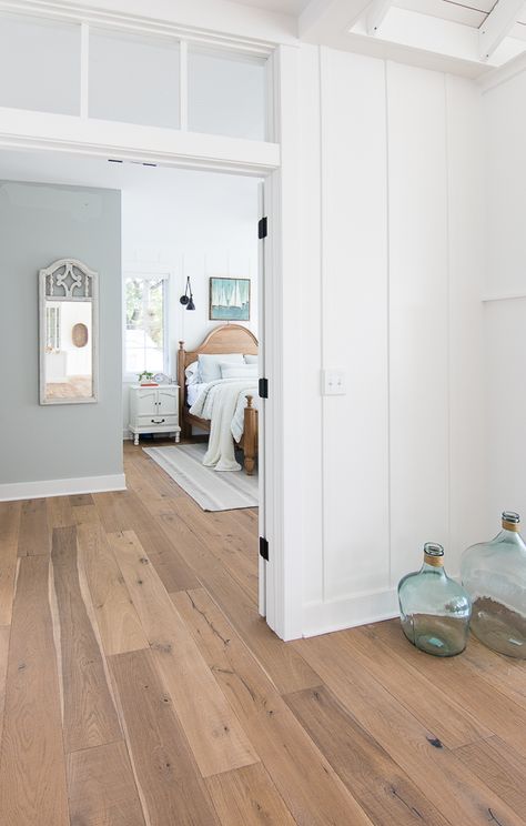 White and Blue lake house master bedroom. Rustic warm woods, white planked walls, and pale blue/gray walls give a serene feeling to this lake home. Blue Lake House, White Plank Walls, Lake House Master, Planked Walls, Blue Grey Walls, House Florida, Bedroom Rustic, Plank Walls, Coastal Bedrooms