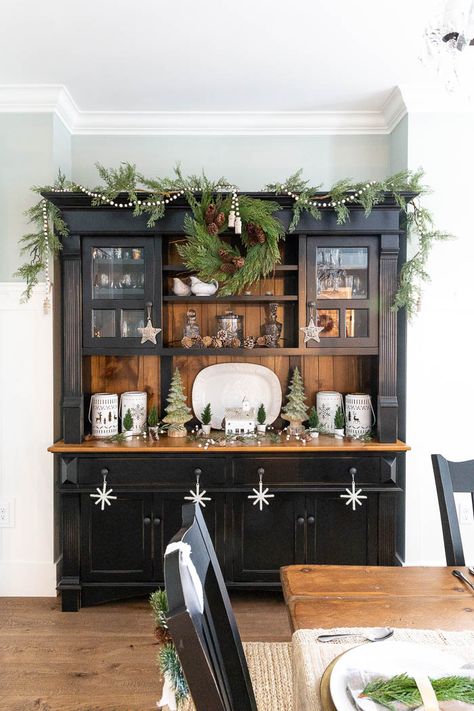 Christmas Decor For Top Of Hutch, Christmas Decor Top Of Armoire, Hutches Decorated For Christmas, Dining Room Hutch Christmas Decor, How To Decorate A Hutch For Christmas, Black Kitchen Christmas Decor, China Hutch Christmas Decor, Hutch Decorated For Christmas, Christmas Decor On Top Of Hutch