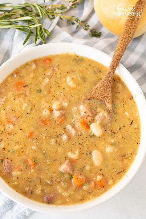 Ham and Bean Soup will warm your soul and belly this season. Hearty chunks of ham, buttery beans and veggies in a savory broth makes this a comforting winter supper. #soup #ham #leftoverham #beans #heartysoup #hamandbeansoup #beansoup #hamsoup #wintersoup #fallsoup #healthysoup #leftovers #hotsoup #navybeans #hambone #souprecipes #greatnorthernbeans #whitebeansoup Ham Bone Soup Recipes, Soup Ham, White Beans And Ham, Healthy Ham, Ham Soup Recipes, Ham Bone Soup, Ham And Bean, Honey Baked Ham, Ham Soup