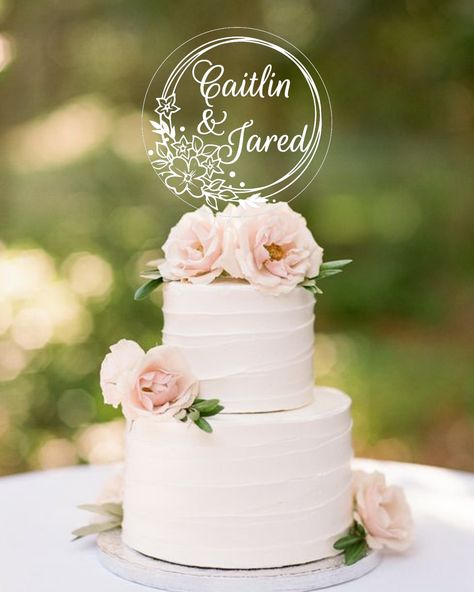 "This personalized round cake topper is cut from clear acrylic and laser engraved with a beautiful floral design with your personalized text for a lasting piece to use year after year. Choice of 4\" or 6\" in circumference to fit your cake perfectly. ------------------------------------------------------------------------------ 15% off coupon code HERE -> https://linktr.ee/AmyPotts 15% off coupon code HERE -> https://linktr.ee/AmyPotts 15% off coupon code HERE -> https://linktr.ee/AmyPotts ----- Acrylic Wedding Cake Topper, 2 Tier Wedding Cakes, Topper Floral, Circle Cake, Mr Mrs Cake Toppers, Floral Cake Topper, Decor Cake, Simple Wedding Cake, Geometric Wedding