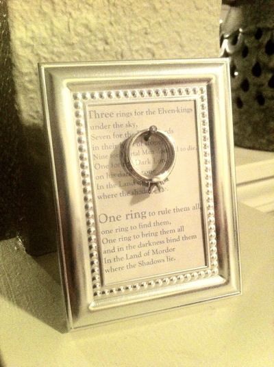 Homemade ring holder using a small frame. The frame idea was from Pinterest--the LOTR quote was my own idea :) You could use any quote you like, really. Lotr Quote, Ring Warming, Small Wedding Rings, Ring Frame, Craft Display, Diy Holder, Three Rings, Small Frame, In Frame