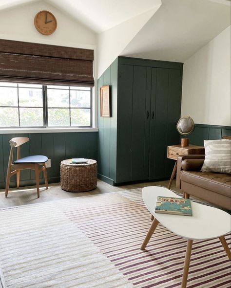 vertical shiplap, green paint, green playroom, kids playroom, wooden woven shades, 1950 beach cottage, modern traditional home, wicker ottoman, globe, brown leather couch, modern coffee table, shared kids bedroom, playroom ideas, playroom inspo Green Playroom, Kids Playroom Ideas, Kitchen Renovation Cost, Modern Traditional Home, Wicker Ottoman, Brown Leather Couch, Kids Shared Bedroom, Playroom Design, Small Living Room Decor