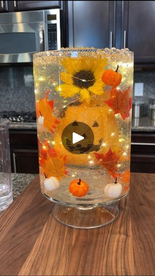 2.9M views · 29K reactions | Easy DIY fall decor 😍 | Easy DIY fall decor 😍 | By Kyle & Mistie's Friends | Drop them in there. Alright and next, you go ahead and pour in some Corby's. Next I'm going to put some fall leaves in here. So we are doing a fall themed Orby decoration. This is going to look so beautiful when I pour the water in. I cannot wait for you guys to see what this looks like. And I have some nice fairy lights here which we're going to put around our decoration. There and you're going to shove it inside. Perfect. Just like that. Okay. Next, you're going to go ahead and put more Orbeez in. More pumpkins. Just put them all around. And we're almost done. This is going to be so pretty. Cannot wait for you guys to see when I put the water in. Next, you take your glass out of he Orbeez Ideas Decor Christmas, Orbeez Crafts, Easy Thanksgiving Centerpieces, Easy Diy Fall Decor, Filled Vases, Diy Fall Decor, Bead Decor, Easy Halloween Decorations, Halloween Centerpiece