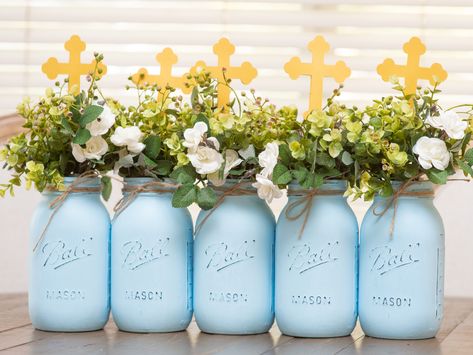 5 Quart Size Mason Jars in Light blue with Greenery/Ivory flowers and gold cross toppers Communion Centerpieces For Boys, First Communion Centerpieces For Boys, Baptism Centerpieces For Boys, Centerpieces For Baptism, Baptism Table Centerpieces, Girl Baptism Centerpieces, Boy Baptism Centerpieces, Baptism Decorations Boy, Christening Decor