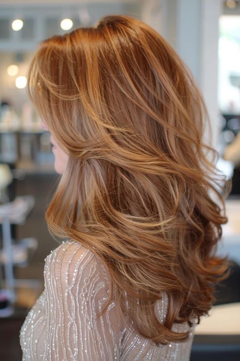 Woman with voluminous, layered light brown hair in a salon setting. Highlights And Lowlights For Red Hair, Rich Auburn Hair Color With Highlights, Natural Red Highlights In Brown Hair Dark Auburn, Light Brown To Red Balayage, Natural Red Head With Highlights, Strawberry Blonde Brown Hair, Blonde To Auburn Hair, Light Brown Copper Hair Color, Strawberry Blonde Highlights In Brown Hair