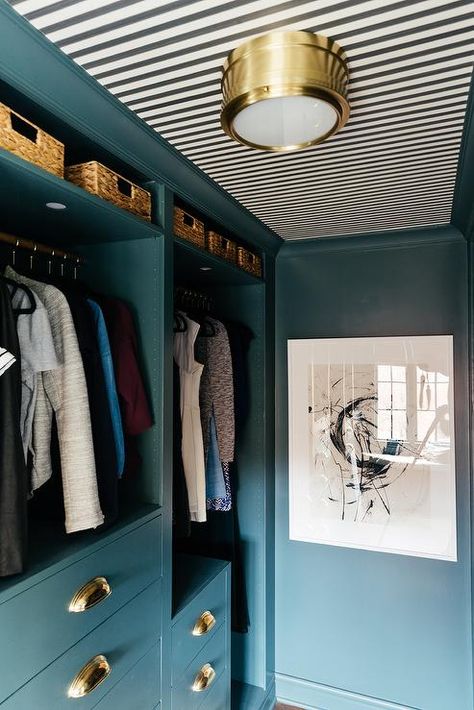 Rye Flush Mount Light fixed to a ceiling covered in Farrow & Ball Closet Stripe Wallpaper lights a blue Ikea Pax closet system fitted with clothing rails located between blue shelves and over blue dressers accented with brass cup pulls. Walk In Closet Ikea, Ikea Closet Hack, Pax Hack, Ikea Pax Hack, Ikea Pax Closet, Pax Closet, Closet Ikea, Pax System, Blue Shelves