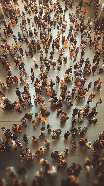 The image captures a densely populated indoor space, viewed from above, showcasing a bustling crowd. Individuals of varied appearances are engaged in various activities, some in groups, while others appear to be in motion, possibly walking through the venue. The overhead perspective emphasizes the sense of scale and the multitude of interactions taking place within this communal area. The warm hues and blurred details contribute to the overall dynamic and lively atmosphere of the gathering. Gathering Of People Art, Gathering Of Objects, Gathering Photography Ideas, Crowd Reference, Overhead Perspective, Gathering Photography, Sketchbook Moodboard, Communal Area, Art Igcse