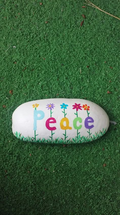 Peace painted on a Lake Huron beach stone by Cindy P 2017 Cool Crafts For Adults Diy Ideas, Rock Garden Sign Ideas, Peace Sign Painted Rocks, Peace Rock Painting Ideas, Stone Painting Garden Rock Art, Peace Painted Rocks, Peace Painting Ideas, Summer Painted Rocks, Easy Things To Paint On Rocks