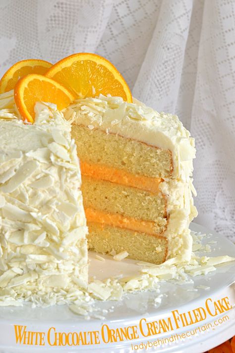 White Chocolate Orange Cream Filled Cake | This wonderfully dense cake has a beautiful colored orange cream filling and white chocolate shavings. A deliciously delightful addition to any Spring or Summer table. Cream Filled Cake, Super Torte, White Chocolate Shavings, Ice Cream Chocolate, Party Cupcakes, Spring Cake, Chocolate Cream Cheese, Orange Cake, Chocolate Shavings