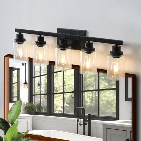 Transform your bathroom with Miniyam's Rustic & Farmhouse Vanity Light. This 4-light fixture seamlessly blends modern black metal with rustic glass elements, creating a simple yet elegant atmosphere. Crafted from high-quality metal and thick tempered glass, it is designed to resist oxidation and fading, ensuring long-lasting durability. Compatible with various E26 base bulbs (maximum 60W, not included), it offers versatility in lighting. Easy to install with all mounting hardware included, this fixture is perfect for farmhouse, urban industrial, or vintage electric interiors. Add a touch of rustic charm and modernity to your home with Miniyam's exquisite bathroom light fixture. Rustic Bathroom Light Fixtures, Rustic Vanity Lights, Farmhouse Vanity Light, Rustic Bathroom Lighting, Modern Black Bathroom, Farmhouse Vanity Lights, Rustic Farmhouse Bathroom, Vanity Lights Bathroom, Black Vanity Bathroom