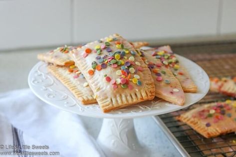 These Pop Tarts are so easy to make with store bought pie crust dough and your favorite jam. It only takes 2 ingredients and some time in the oven and you will have your own, sweet and delicious homemade pop tarts! #poptarts #homemade #recipe #snack #breakfast #dessert www.lifeslittlesweets.com Strawberry Poptarts, Homemade Pop Tarts, Poptart Recipe, Valentines Recipes Desserts, Store Bought Pie Crust, Pie Crust Dough, Butter Tarts, Pop Tart, Low Carb Cheesecake