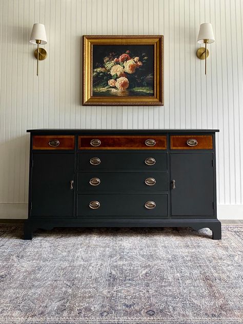 *BUFFET AVAILABLE!* This Hepplewhite buffet turned out divine! This is the first time we have decided to do a black and mahogany two-tone look leaving the upper portion of drawers on a buffet in original condition. This vintage buffet was in spectacular condition for its age but we wanted to take it to the next level. This solid wood sideboard has a whole new modern farmhouse/transitional feel with a fresh matte black exterior as well as the original oval Hepplewhite hardware touched up in brassy-gold for extra shine. The drawers and cabinet portions on either side of this buffet holds plenty of storage and ample space. The top theee drawers don a lovely organic modern style drawer liner. Use this buffet in a dining room, living room, as an entryway console, a media entertainment center, o Dining Room Dresser Styling, Refurbished Buffet Ideas, Buffet Refurbished, Style Buffet Cabinet, Antique Buffet Makeover, Side Board Buffet, Modern Farmhouse Transitional, Refinished Buffet, Two Tone Furniture