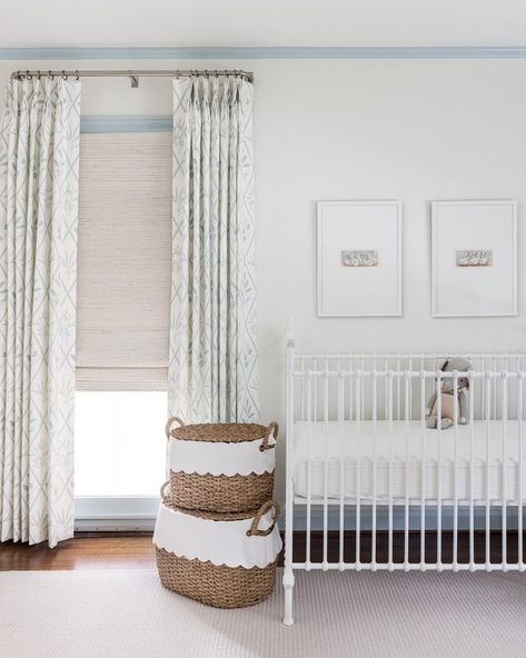 Crib In Front Of Window Nursery, Crib In Front Of Window, White And Blue Nursery, Green And Blue Pillows, Blue Roman Shades, Green Floral Curtains, Transitional Nursery, Layered Window Treatments, Modern Boy Nursery