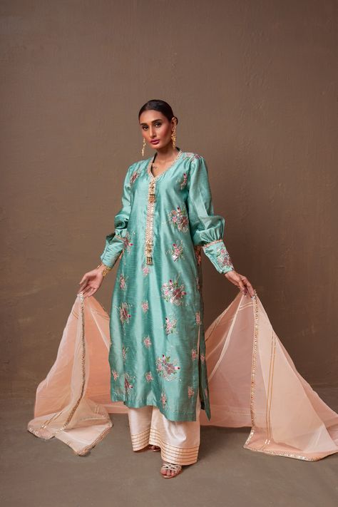 A ferozi colored, raw silk shirt with floral hand-embroidery and a net, organza pearl white dupatta and raw silk ajar pants.3-Piece SuitReady to wear Silk Suit Design, White Dupatta, Raw Silk Fabric, Outfits Woman, Silk Suit, Suit Design, Mint Blue, Designer Outfits, Embroidery Suits