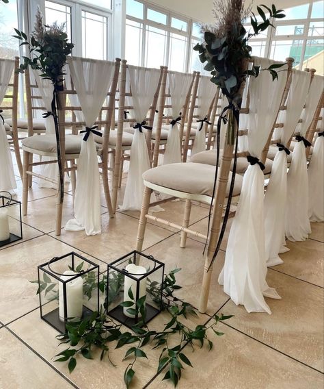 This is a much more simplistic visual of the type os styling that we are having on all of the chairs for the actual ceremony. We have more white material, larger black bow and a diamante broach in the centre. Their are also florals to the back of the aisle chairs in fan shape, and a variety of candles in vases along each side of the aisle. Black Chair Sashes Wedding, Chivari Chair Draping, Wedding Isle Candles, Candles In Vases, White Chairs Wedding, Chiavari Chairs Wedding, Chair Styling, Uk Party, Wedding Chair Sashes