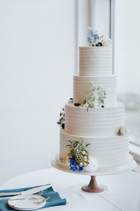 This four-tiered wedding cake paired perfectly with the coastal blue aesthetic. Blue And White Wedding Cake 1 Tier, Blue Wedding Cake 3 Tier, Pale Blue And White Wedding Cake, 2 Tier Wedding Cake Blue And Pink, Wedding Cake Light Blue Flowers, Dessert Inspiration, New England Wedding, Pinch Me, Unique Wedding Cakes