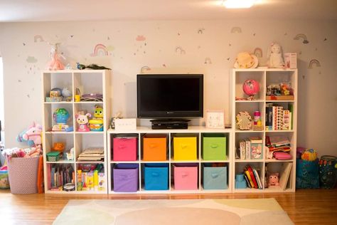 Playroom Ideas Shelves, Storage Cube Entertainment Center, Toy Room Organization Wall Shelves, Ikea Playroom Shelves, Ikea Kallax Configuration, Playroom Entertainment Center, Cube Storage Entertainment Center, Cube Organizer Ideas Bedroom Kids, Playroom Shelf Organization