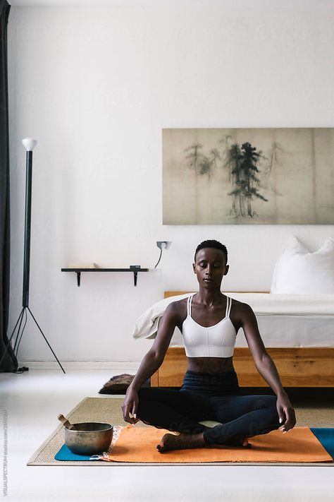 A slim and attractive black woman meditating with eyes closed on the floor in a beautiful white bedroom. The large print of Japanese pine trees is in the public domain. Woman Meditating, Yoga Poses For Back, Yoga Photoshoot, Woman Yoga, Outfit Yoga, Downward Dog, Pose Yoga, Pilates Studio, Kundalini Yoga