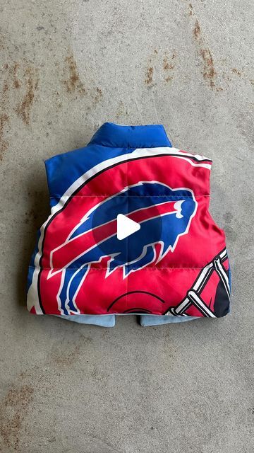 Upcycled gameday outfits on Instagram: "Puffer vest upcycled out from a vintage Buffalo Bills flag. Just about anything can be re-imagined onto a basic pattern. I did not make this pattern, I bought it off etsy! Will link the one i used in my bio :) Should I make more of these?? Got inspired to use this pattern after I saw @kristinjuszczyk make a 49ers one. I love how mainstream upcyling has become. Being intentional with the resources we already have is always more ethical than buying new. When you try this pattern, challenge yourself to use materials that are already in your closet (minus the thread and stuffing obviously, lol) Can’t wait to see what you guys create :)" Game Day Diy Outfit, Football Sewing Projects, Diy Puffer Vest, Buffalo Bills Outfit Woman, Diy Game Day Shirt College, Buffalo Bills Diy, Vest Pattern Sewing, Buffalo Bills Outfit, Sports Jersey Outfit