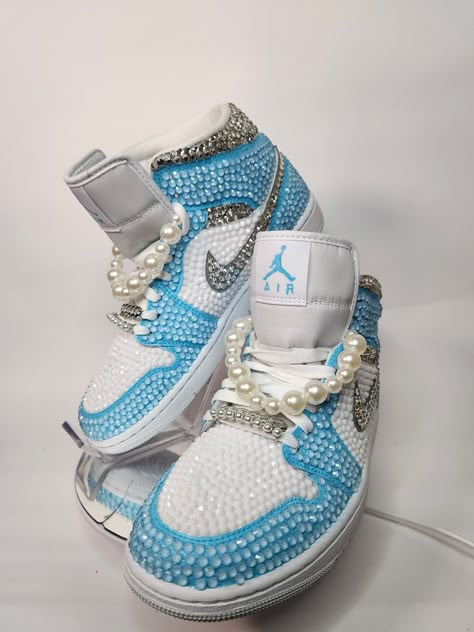 Step up your sneaker game with some fully blinged Jordan 1 mids. These shoes are a great addition for prom, a birthday, a wedding, a night on the town, or your  next event! These shoes can be customized to the colors of your choosing. Not looking for Jordan 1's? Message me with your shoe choice. I'd love to create the custom shoe of your dreams.  Please note that the shoe charms ARE NOT included in this listing. You can purchase them as a bonus add on by selecting the "extras listing" on my shop Bedazzled Stuff, Rhinestone Sneakers, Jordan 1 Mids, Cute Casual Shoes, Nike Shoes Women Fashion, Bedazzled Shoes, Casual Shoes Women Sneakers, Sneaker Ball, Shoes Women Sneakers