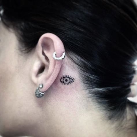 Subtle behind-the-ear tattoo by Wild and Wicked Tattoo. #ear #behindtheear #eye… Behind Ear Tattoo Evil Eye, Eye Tattoo Behind Ear, Evil Eye Ear Tattoo, Eye Behind Ear Tattoo, Witch Tattoo Behind Ear, Small Evil Eye Tattoo Behind Ear, Eye On Neck Tattoo, Space Tattoo Behind Ear, Evil Eye Tattoo Behind Ear